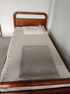 a small bed in a small room with a mattress at Moonshadow in Sungai Kolok