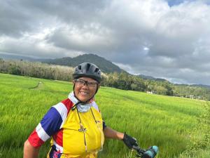 a man riding a bike in a field at Moonshadow in Sungai Kolok