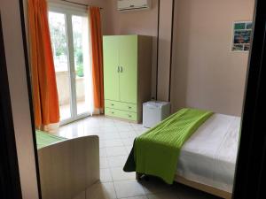 a bedroom with a bed and a green cabinet at B&B L'Angolo in Sannicola +50 photos