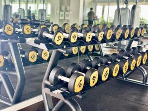 a row of barbells in a gym at Kenwingston Cyberjaya Wifi Free Parking in Cyberjaya