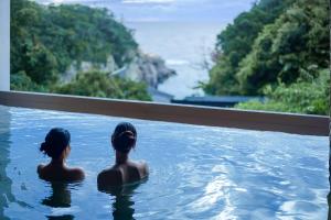 two women in a swimming pool looking out at the ocean at TAOYA Shirahama Senjyo in Shirahama +54 photos