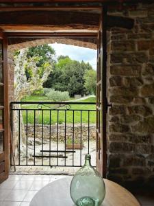 a glass vase sitting on a table in front of a door at Mas d'Aimée in Martignargues +2 photos