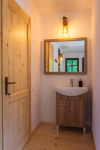 a bathroom with a sink and a mirror at Jókai Guesthouse in Tuşnad
