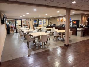 a dining room with tables and chairs in a restaurant at Comfort Inn & Suites Black River Falls I-94 in Black River Falls