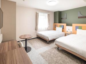Postel nebo postele na pokoji v ubytování Comfort Hotel Narita