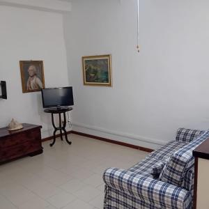 a living room with a couch and a tv at Casa Milanesi in Monterosso al Mare +21 photos