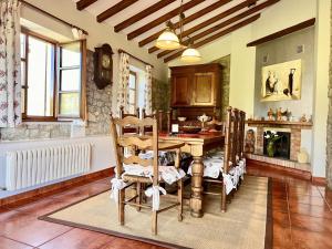 a kitchen with a table and chairs in a room at Villa Mogro Cueto Hills - Monabri in Mogro
