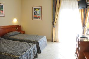 Postel nebo postele na pokoji v ubytování Hotel Barbieri