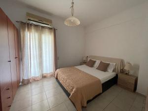 a bedroom with a bed and a large window at Heaven Studios & Apartments in Stalís