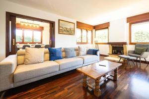 a living room with a couch and a table at Casa Costera Gijón By Silastur in Gijón