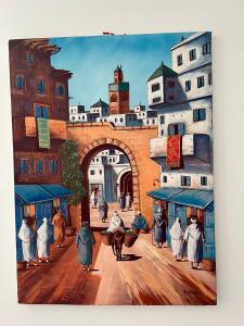 a painting of people walking down a street at Maison Berj in Oualidia