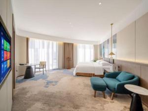 a hotel room with a bed and a tv at Northwest Petroleum Hotel in Ürümqi +231 photos