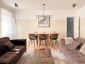 a living room with a couch and a table at Henrietes Apartamenti in Kuldīga