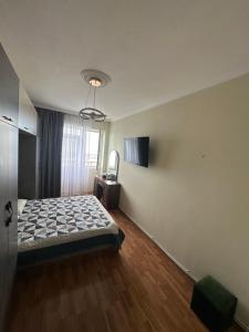 a bedroom with a bed and a television in it at McDonald's in Itʼkhvisi
