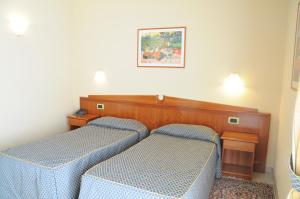 Postel nebo postele na pokoji v ubytování Hotel Barbieri
