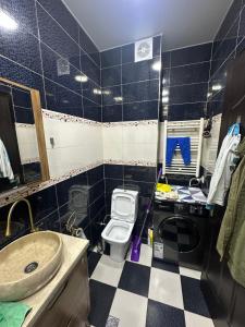 a bathroom with a sink and a toilet at McDonald's in Itʼkhvisi