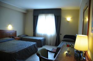 Postel nebo postele na pokoji v ubytování Hotel Barbieri