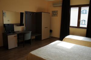 Postel nebo postele na pokoji v ubytování Hotel Barbieri