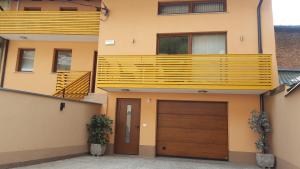 a house with a garage and a balcony at Rooms and Apartment Soča Kobarid in Kobarid