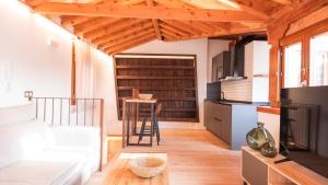 a living room with a couch and a table at Cárcel del Vicario by Toledo AP in Toledo