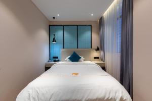 Postelja oz. postelje v sobi nastanitve Warm Yes Business Hotel -Free shuttle bus during the Canton Fair