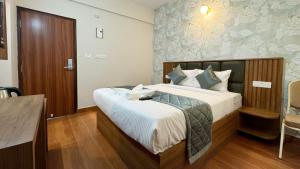 a bedroom with a large bed in a room at Dream Inn in Bangalore