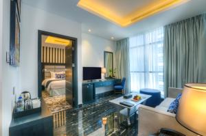 a hotel room with a bed and a living room at Signature 1 Hotel Tecom in Dubai