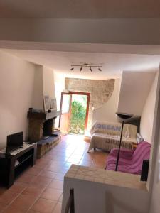 a large room with a bed and a fireplace at Maison de village Frasseto in Frasseto +2 photos