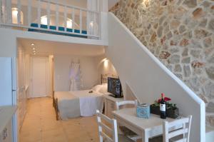 a bedroom with a bed and a staircase in a room at Kathara Bay Apartments in Faliraki