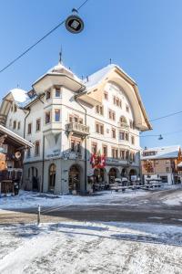 a large building with a clock on top of it at Hotel Landhaus in Gstaad