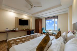 Postel nebo postele na pokoji v ubytování HOTEL NEU VILLA - New Delhi City Center