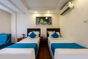 Postel nebo postele na pokoji v ubytování HOTEL NEU VILLA - New Delhi City Center