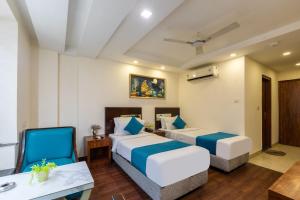Postel nebo postele na pokoji v ubytování HOTEL NEU VILLA - New Delhi City Center