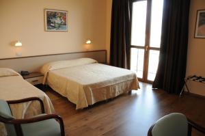 Postel nebo postele na pokoji v ubytování Hotel Barbieri