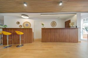 a waiting room with yellow bar stools in a lobby at Marina Suites & apartments - Self catering - by Tritoni hotels in Il-Gżira +229 photos