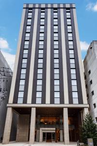 a tall building with a lot of windows at Hotel Vista Sendai in Sendai