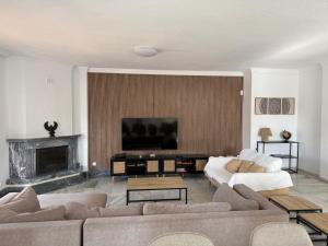 a living room with two couches and a flat screen tv at Villa del Mar in Torremolinos