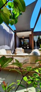 a balcony with wicker chairs and a table at Stylish beach house in Privlaka in Privlaka