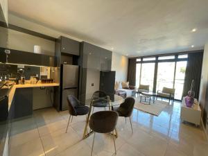 a kitchen and living room with a table and chairs at Zayna in Johannesburg