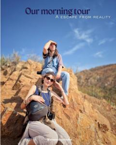 two women are sitting on top of a rock at Whereabout Hostel Udaipur in Udaipur