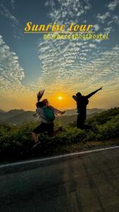 two people jumping on the side of a road at Whereabout Hostel Udaipur in Udaipur