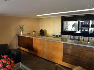 a man sitting at a bar in a hotel room at ApartmentFortaleza Porto de Iracema in Fortaleza