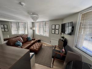 a living room with a couch and a table at Galtres Chambers Apartment Coppergate in York