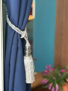 a rope tied to a blue curtain at San Antonio Beach Guesthouse & Restaurant in Kata Beach +22 photos