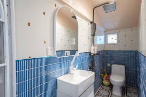 un bagno piastrellato blu con un water e un lavandino di Xizhi B&B & Two-bedroom House a Shanghai