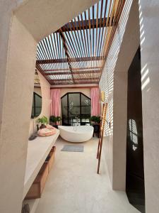 a bathroom with a large tub and a large window at Lugadia Villas in El Nido +143 photos