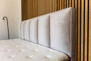 a white headboard of a bed in a room at Prázdninový dům Mikulov in Mikulov