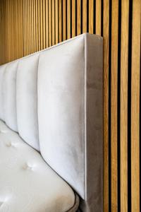 a white couch sitting next to a wall at Prázdninový dům Mikulov in Mikulov