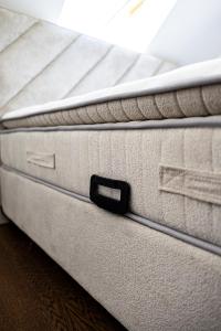 a close up of a white mattress with a black latch at Prázdninový dům Mikulov in Mikulov