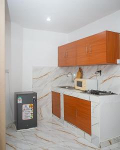 a kitchen with a sink and a microwave on a counter at Clarah's paradise 2 in Mombasa